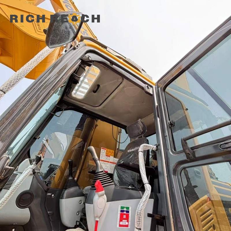 Side profile of a 2018 Komatsu PC200 excavator showing boom and arm, $25,000